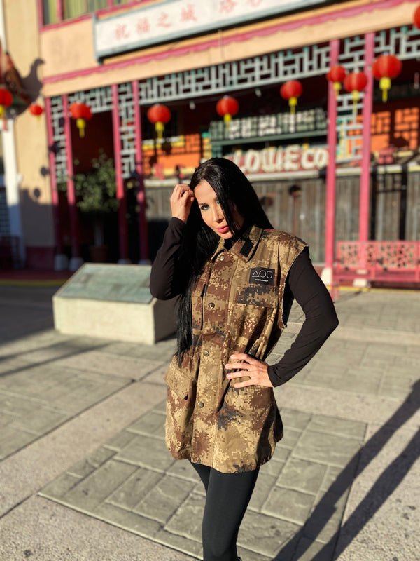 Model in DTLA Chinatown wearing a Chinese digital camo jacket with a large dragon medallion art print on the back.