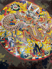 Detail image of the dragon medallion artwork from 16th century China printed on the back of a Chinese military camo jacket.