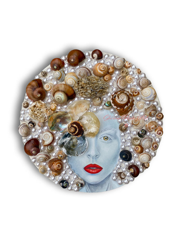 "Tempest" mixed media art by Shireen Renee features a circular 12" x12" canvas with a portrait of a woman with bluish skin and red lips, surrounded by seashells and Swarovski pearls. 
