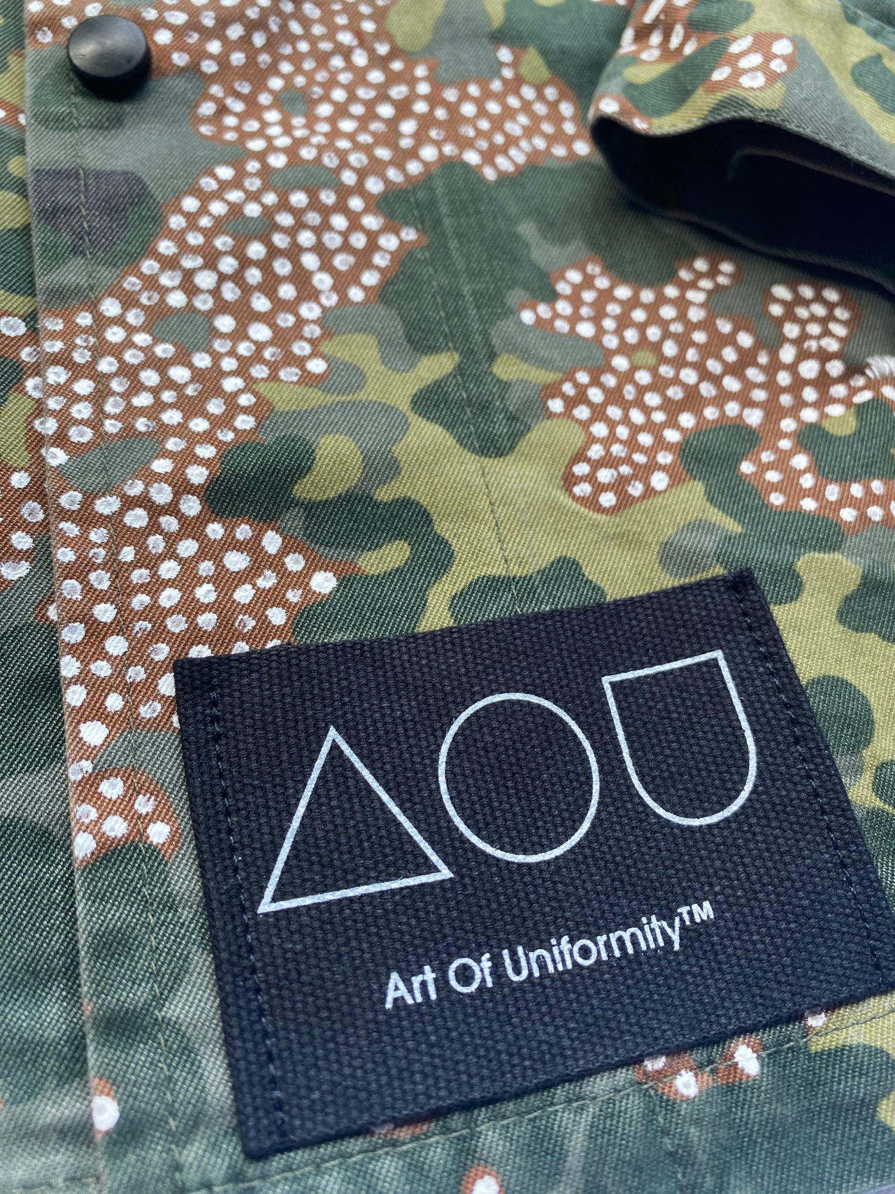 The "Frost" jacket is a vintage 80s German camo jacket with tiny, hand-painted white dots inside the brown parts of the flecktarn pattern.