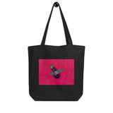 Black organic cotton tote bag featuring "BAE", an original work of art by Shireen Renee depicting a duct-taped eggplant against a hot pink background.
