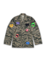 Front view of an American camo jacket with hand-painted pop lip art in different colors throughout the jacket.