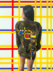 Model wearing a vintage Dutch camo jacket hand-painted with Piet Mondrian's "Broadway Boogie Woogie."