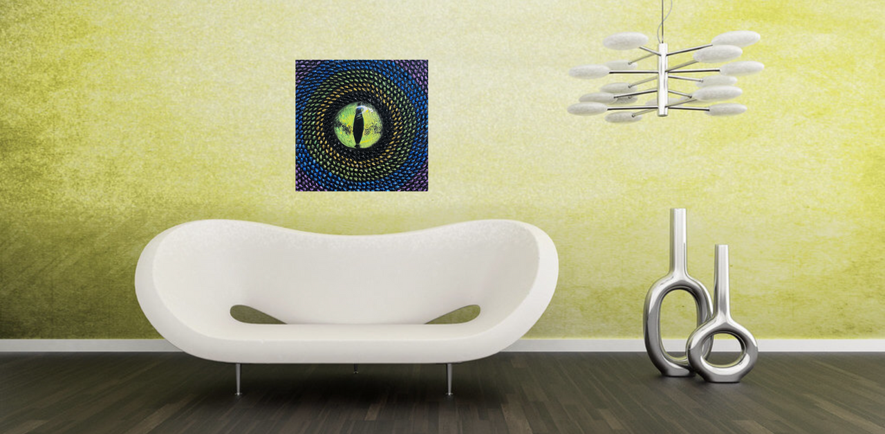 Original contemporary mixed media art by Shireen Renee with a realistic green reptile eye painted in the center, surrounded by pistachio shells painted with metallic multicolor acrylics of black, gold, green, blue and purple. The art is hanging in a futuristic room setting hanging on a bright green wall above a white couch.