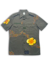 Vintage French 90's button down army shirt in olive green with large hand-painted orange-yellow poppies on the front and back.