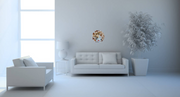 "Tempest" mixed media art by Shireen Renee features a circular 12" x12" canvas with a portrait of a woman with bluish skin and red lips, surrounded by seashells and Swarovski pearls. The image shows the artwork hanging on a plain white wall in a modern living room above a white couch.