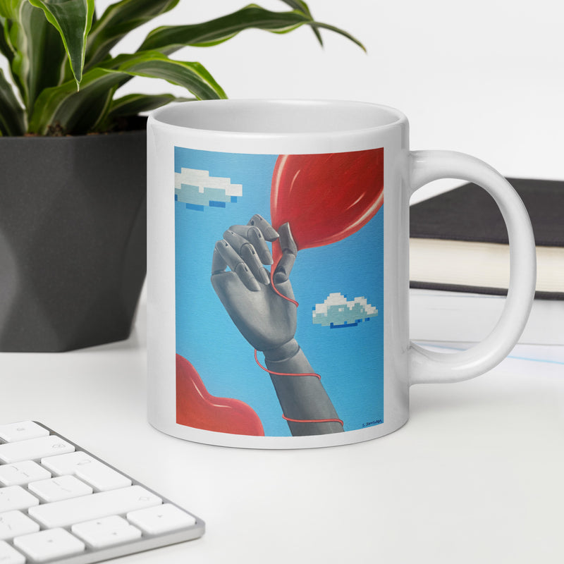 White glossy ceramic mug with original art "The Game" depicting a mannequin hand holding a red balloon against a sky blue background with floating pixelated clouds.